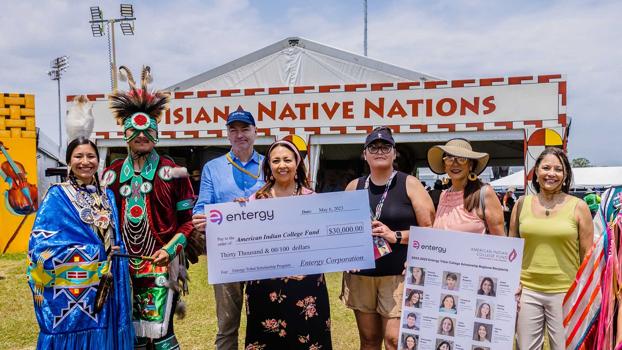 Entergy leaders present a check at Jazz Fest to help Native students attain higher education 