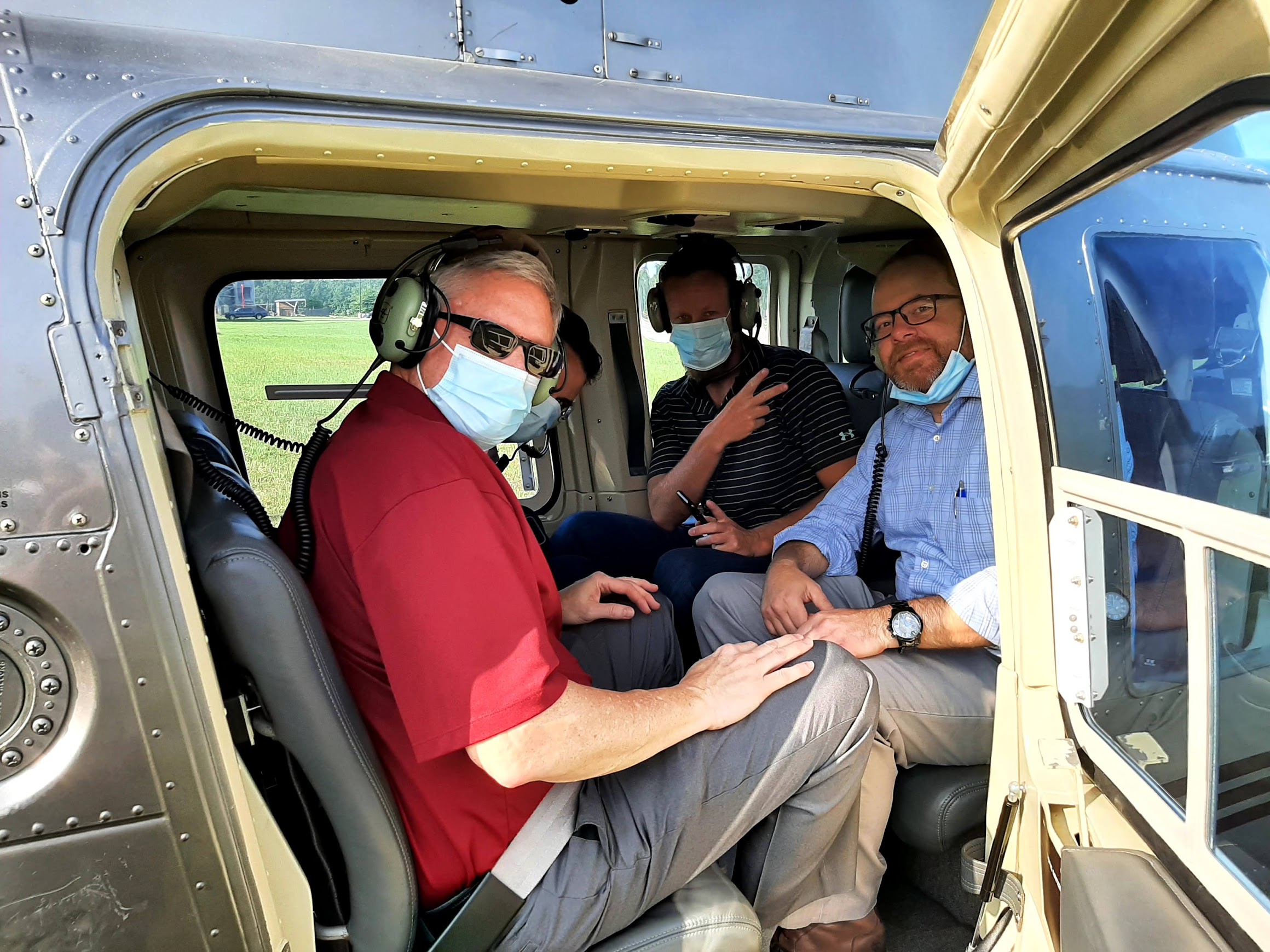 four men in helicopter