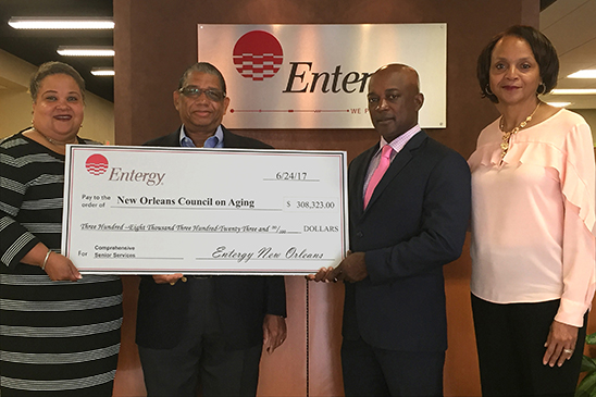 Entergy New Orleans President and CEO Charles Rice presents more than $300,000 to New Orleans Council on Aging Executive Director Howard Rodgers to help those in need. Joining them are Entergy New Orleans' Demetric Mercadel (l) and Toni Green-Brown (r).