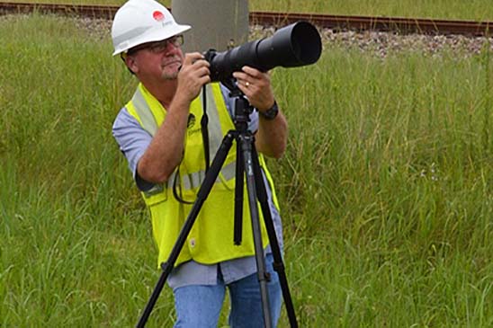 Entergy employee Pat Hoffpauir uses a high-powered camera to inspect the health of the electric grid.