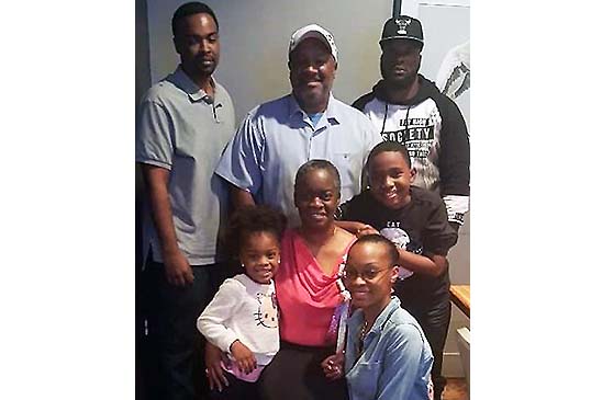 Marcia (middle) is the center of her family's universe! Back row: son Clarence Jr. (CJ), husband Clarence Sr., son Jeremy; middle row: grandchildren Kelani and Javin; and in front, kneeling, is daughter Kristi.
