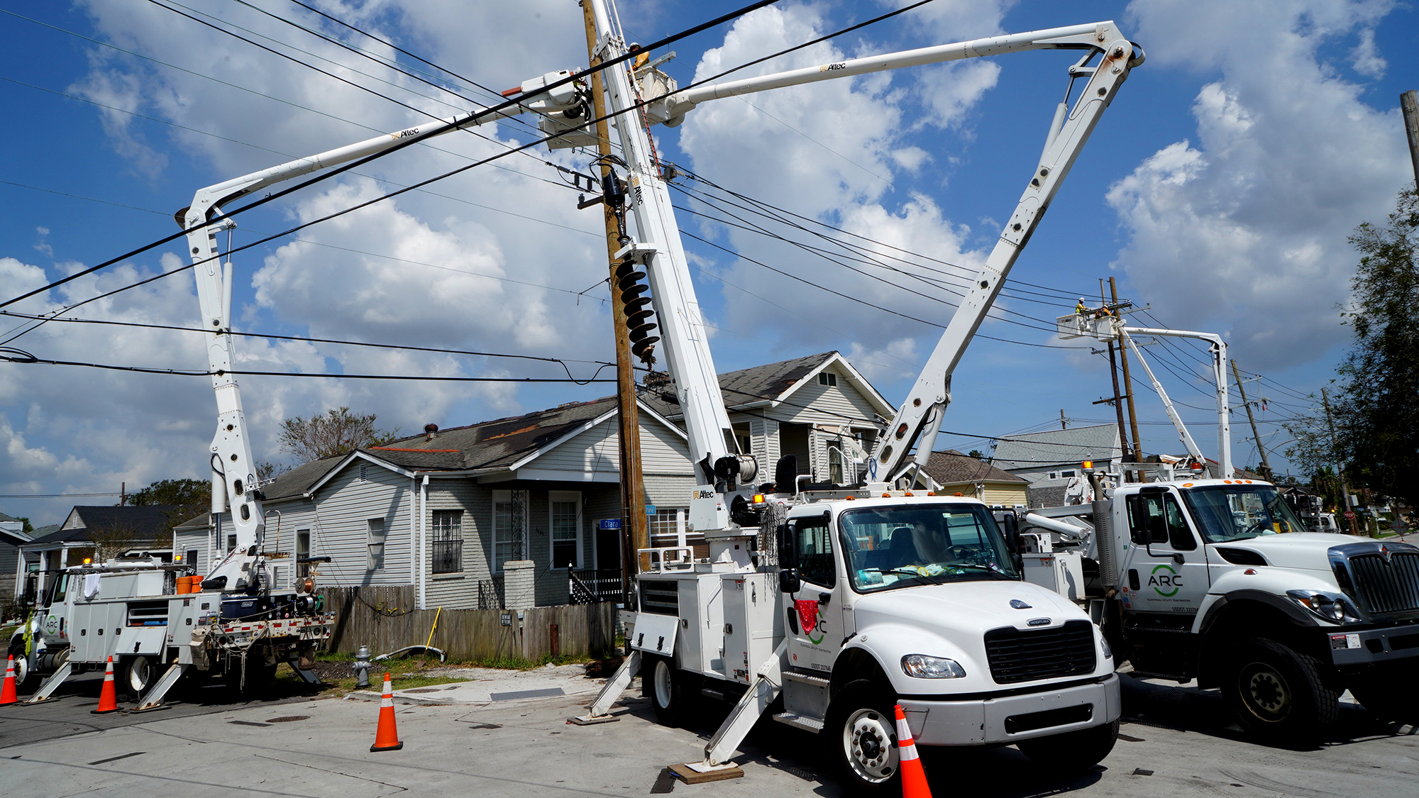 Line workers repair hurricane damage near Tulane Stadium in New Orleans Friday.