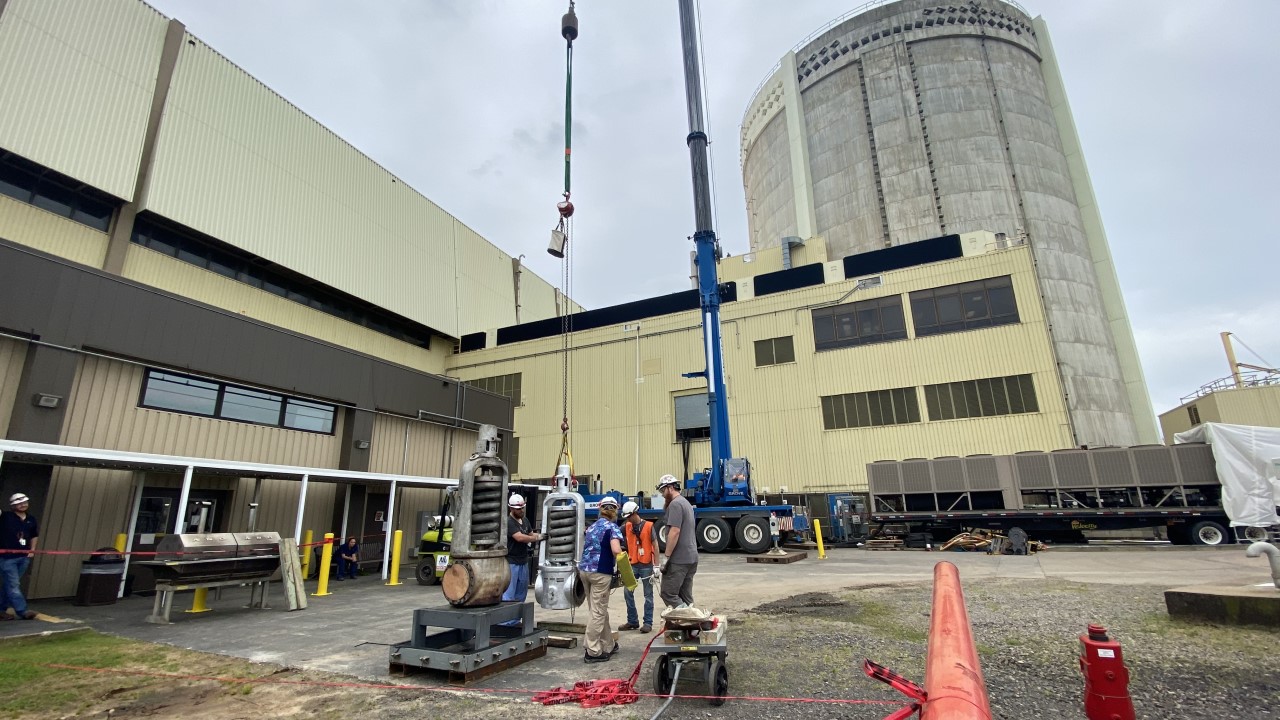 Team members move heavy equipment to support the millions of dollars of investments spent during ANO's spring refueling outage.