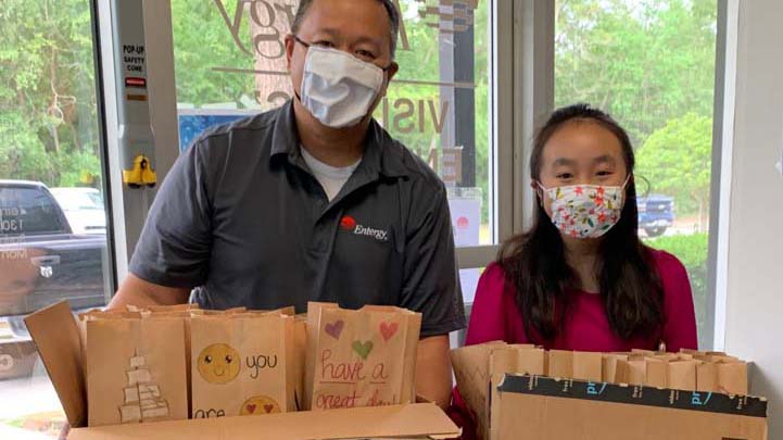 Phong Nguyen and his daughter, drop off their handmade lunch bags for delivery to Kids’ Meals.