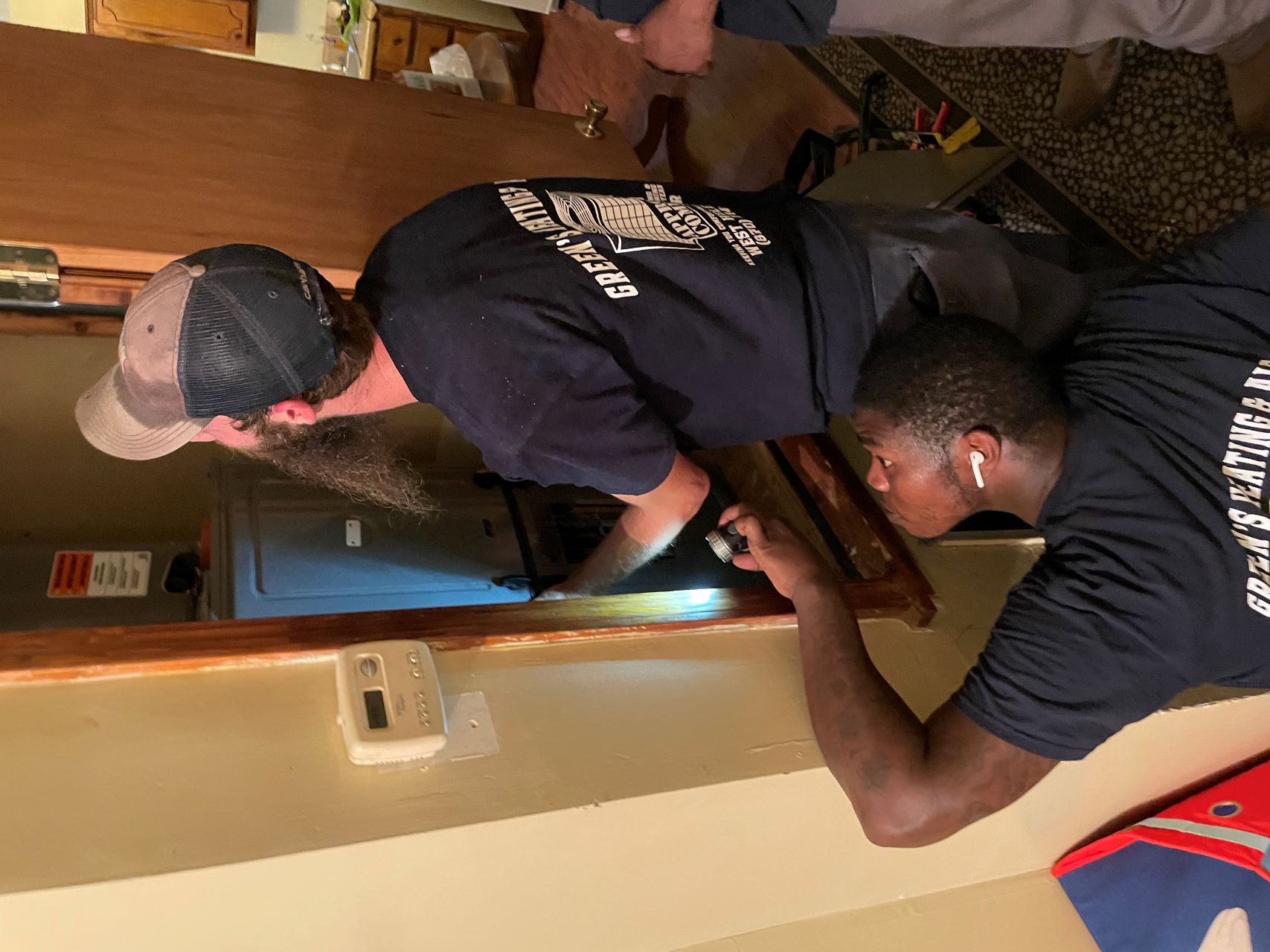 A Green's Heat & Air team installs a new HVAC unit for Entergy Arkansas customer Brenda Haymer in Helena.