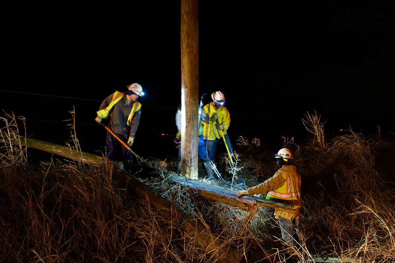 Crews work through the night to replace some 400 broken poles.