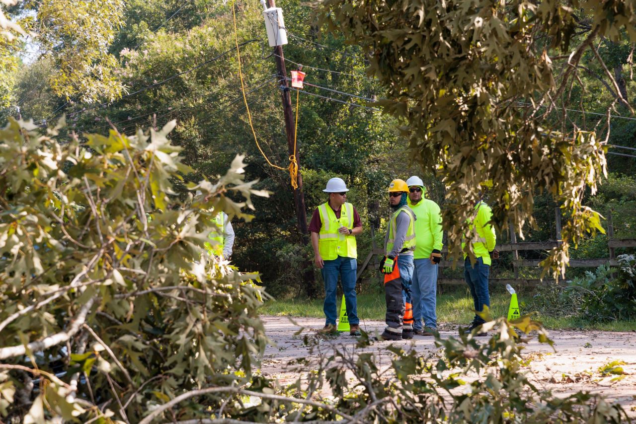 Entergy Texas president and CEO Eliecer Viamontes with restoration workers following Hurricane Beryl