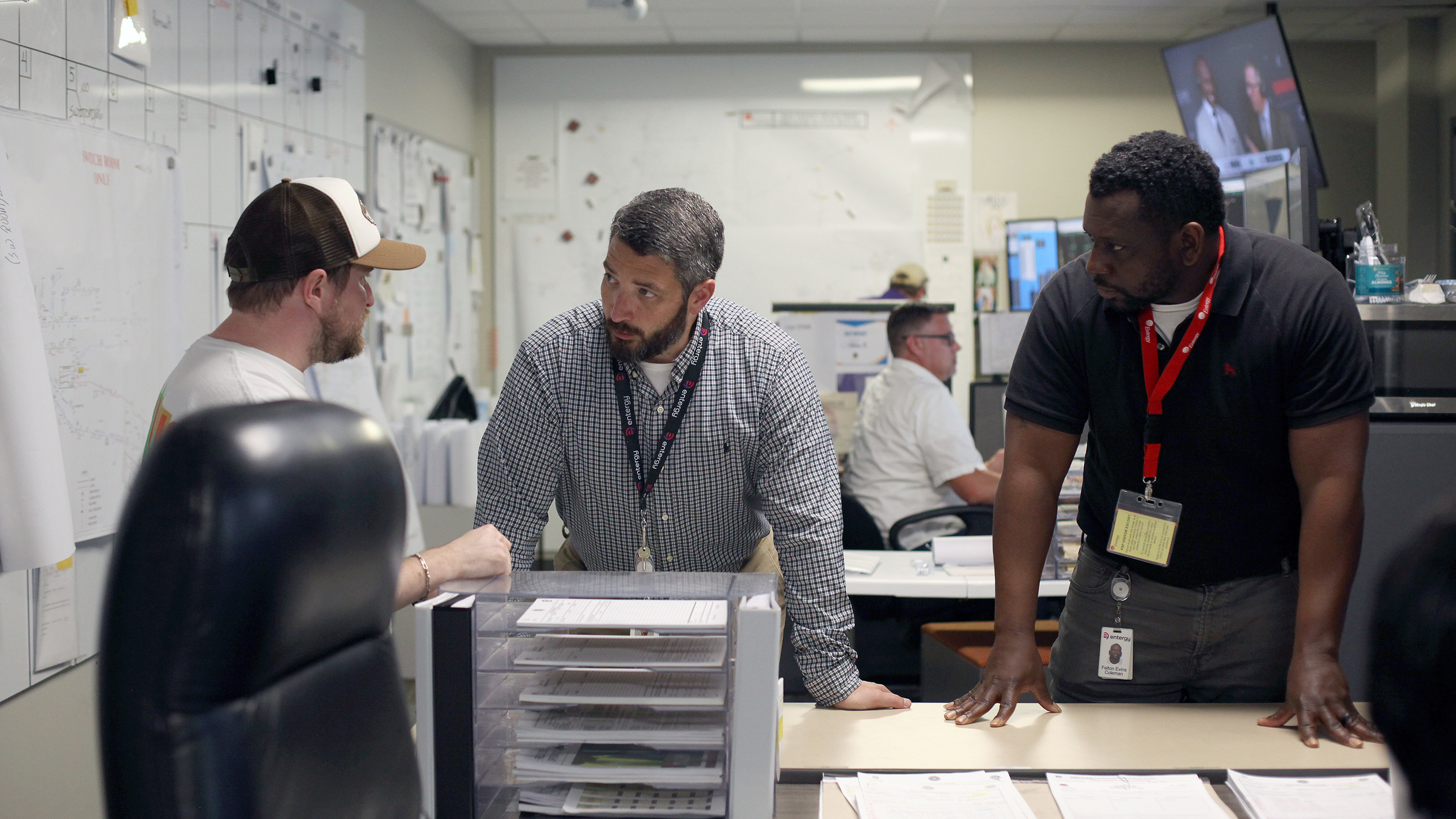 Drew Angelloz, Entergy operations coordinator, and Timothy Santos, Entergy distribution dispatch supervisor, and Felton Coleman, Entergy Louisiana distribution control center manager, are pictured in the switch room at the Louisiana Distribution Operations Center in Baton Rouge.