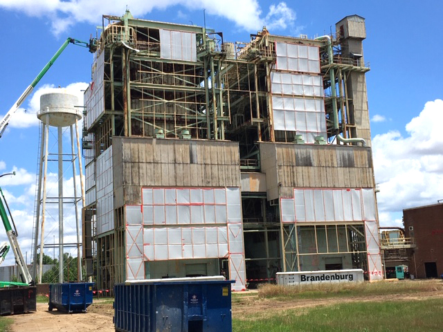 Workers have partially completed installing an airtight barrier around the Moses Plant as preparation for demolition. 