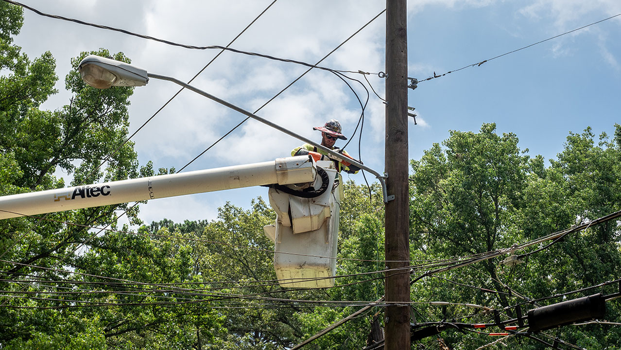 Crews work to restore power on Woody Road near Beatrice Road in Jackson, Mississippi.