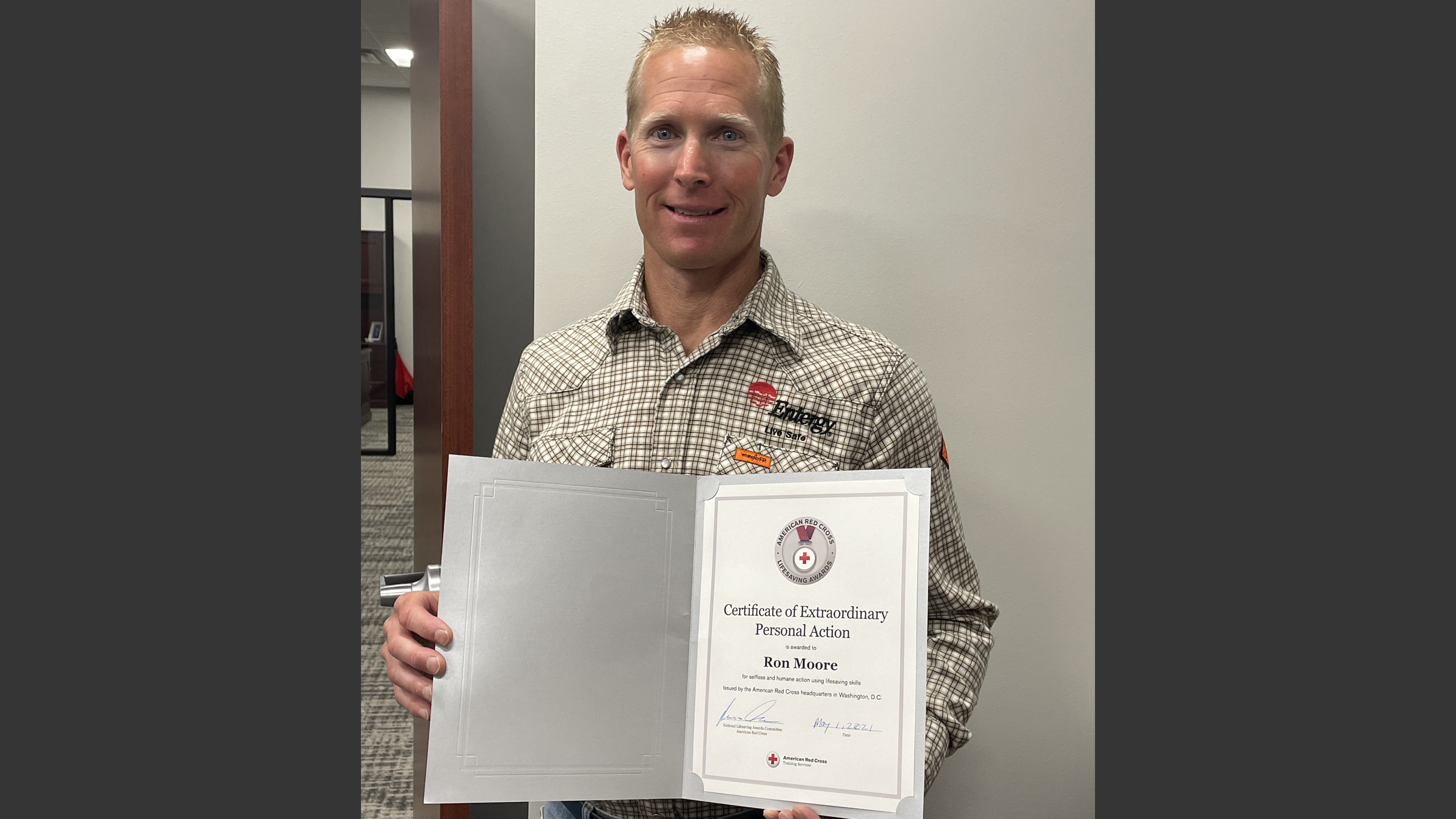 Ron Moore, Entergy Louisiana safety specialist, is pictured holding a lifesaving award from the American Red Cross.