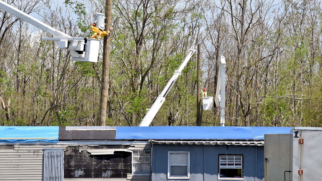 Distribution lineworkers install new electric equipment from buckets in the air in the Terrebonne Parish community of Chauvin. 