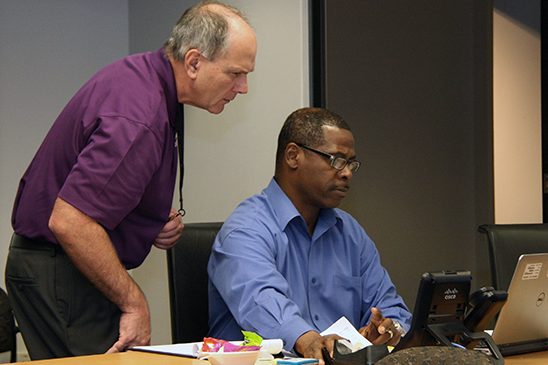 Entergy CEO Leo Denault (left) discussing GridEx with  Director of Incident Response Louis Dabdoub.