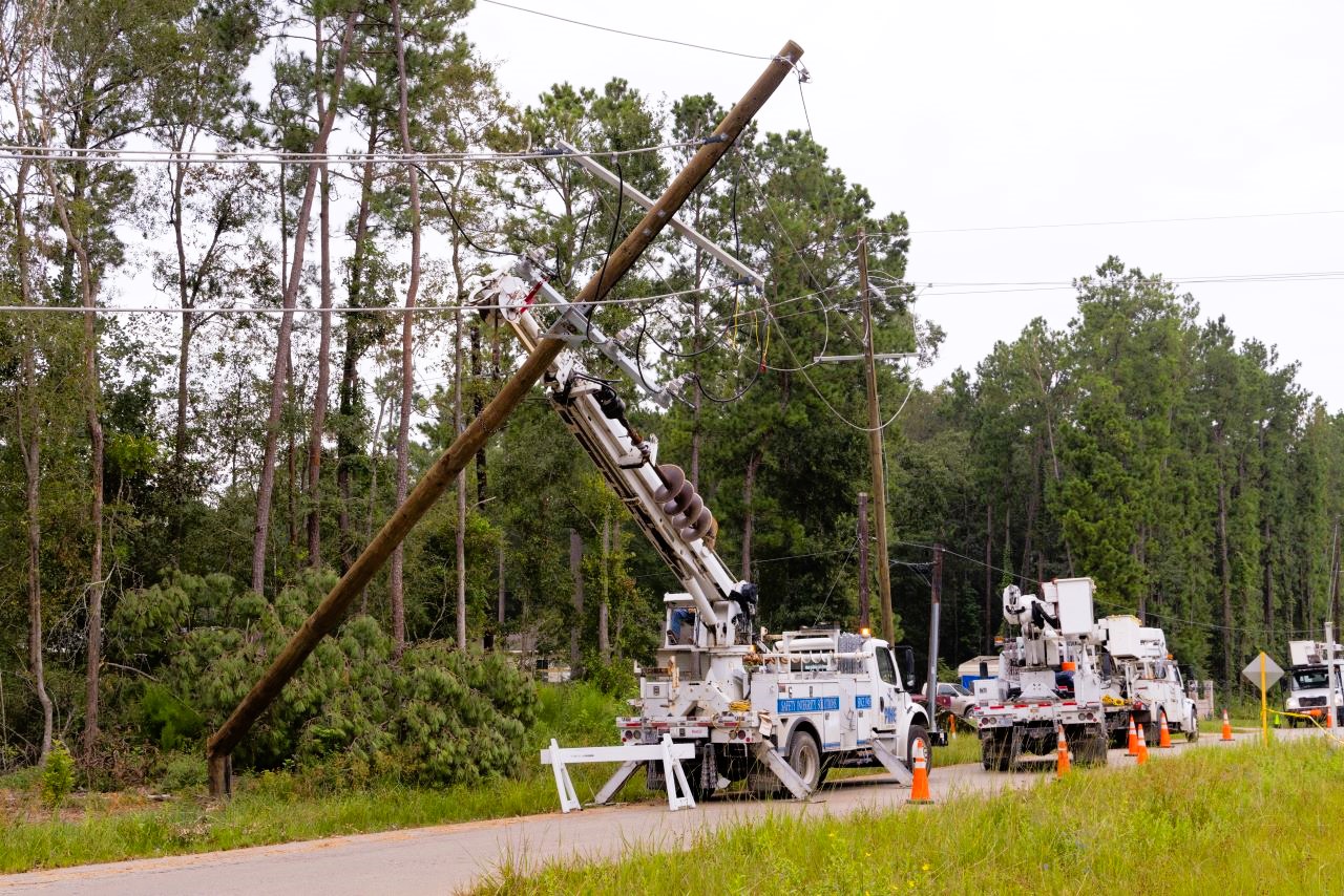 Line crews repair downed power poles in New Caney, Texas